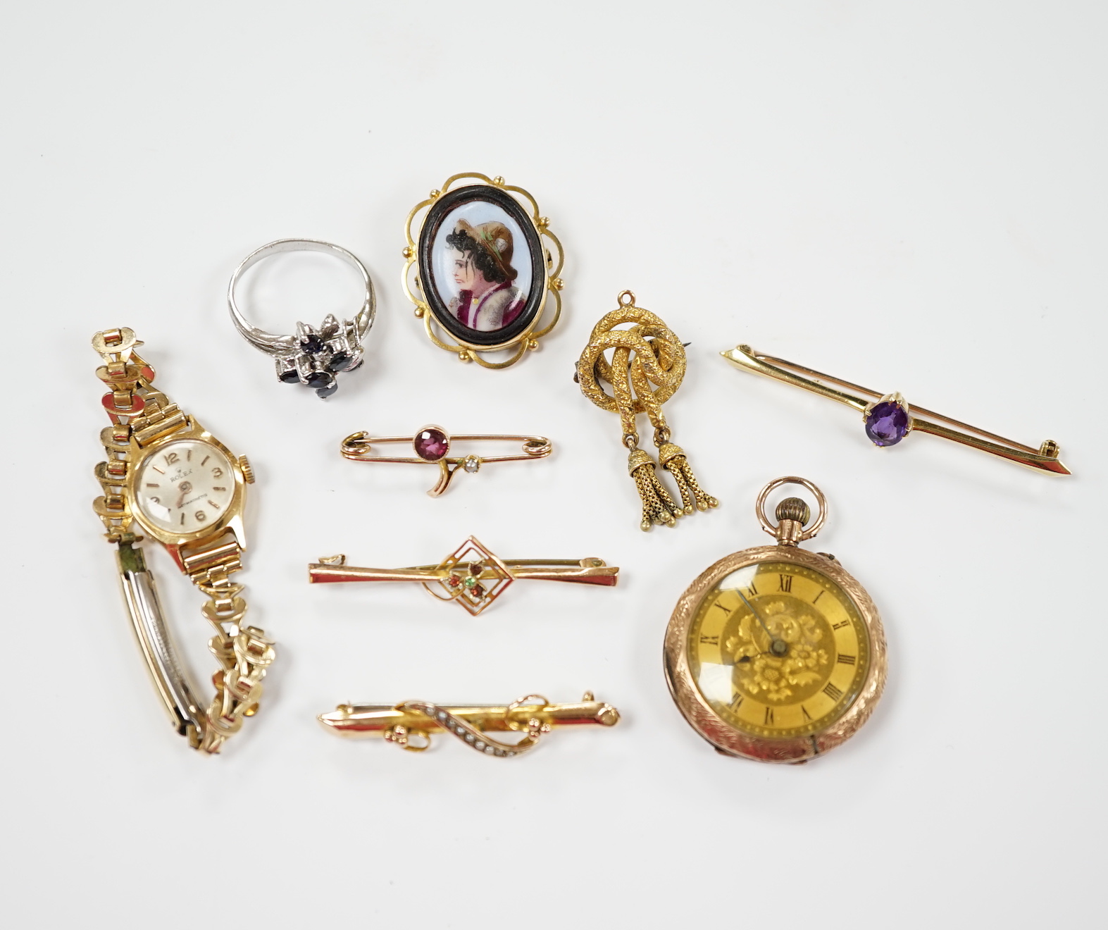 A group of assorted jewellery including a 15ct and single stone amethyst bar brooch, three other yellow metal and gem set bar brooches including two 9ct, a 9ct and enamel brooch, an 18ct watch, a 9ct fob watch and two ot